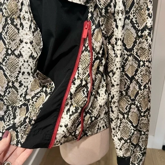 ALALA snakeskin anorak with red accents